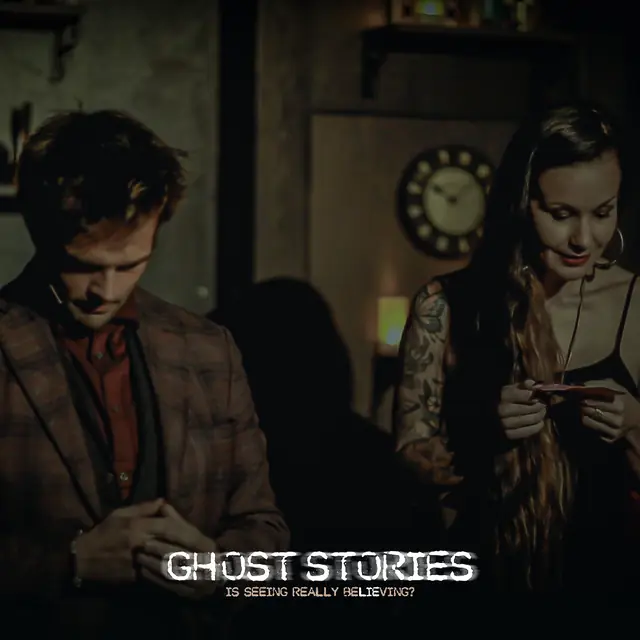 Kent Axell and a guest both looking down at a card in her hands