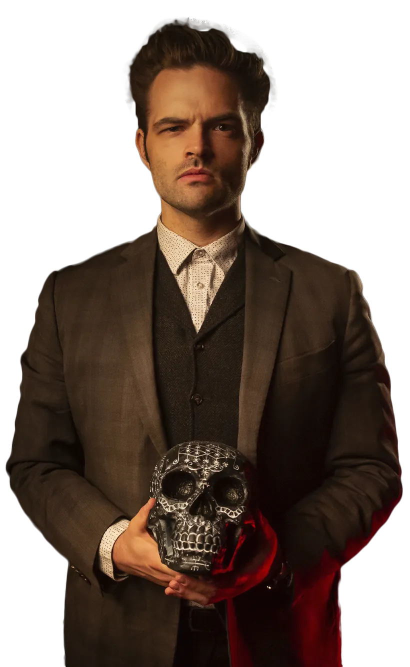 Kent Axell in a tweed suit, holding an ornate silver skull