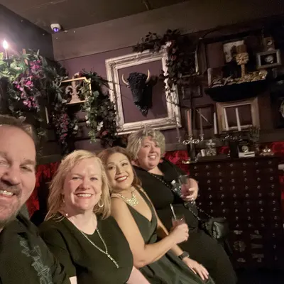 A group of guests taking a selfie at their table before the show