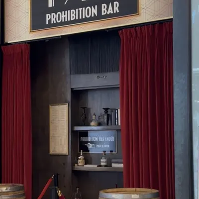 The 1923 Prohibition Bar sign above the velvet-curtained doorway